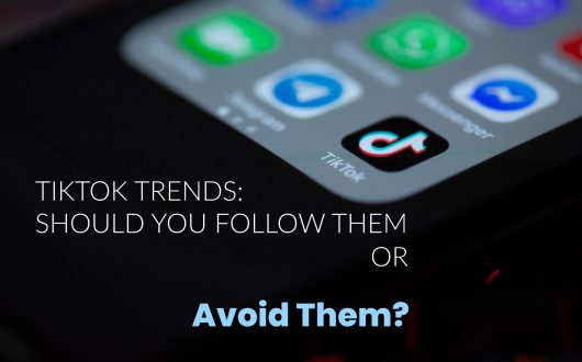 TikTok-Trends-Should-You-Follow-Them-Or-Avoid-Them-Phone-with-TikTok-App-Icon